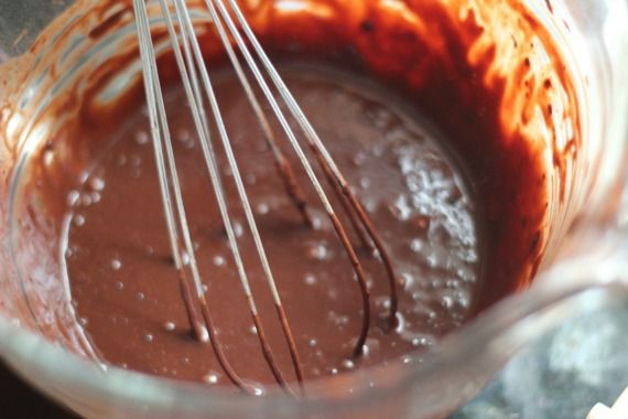 Chocolate cake batter in a mixing bowl with a whisk