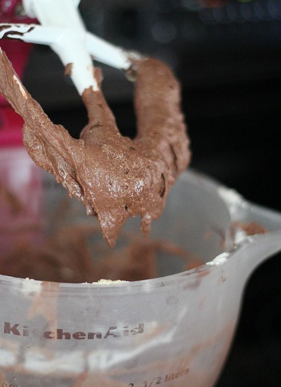 Chocolate cake batter on a stand mixer bowl and beater