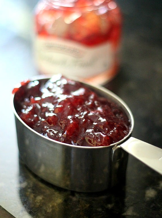 Strawberry jam in a measuring cup