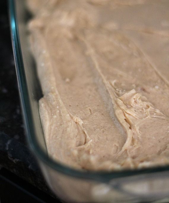 Cinnamon Roll Cookie Bar batter in a glass pan