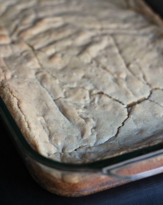 Baked cinnamon roll cookie bars in a glass pan