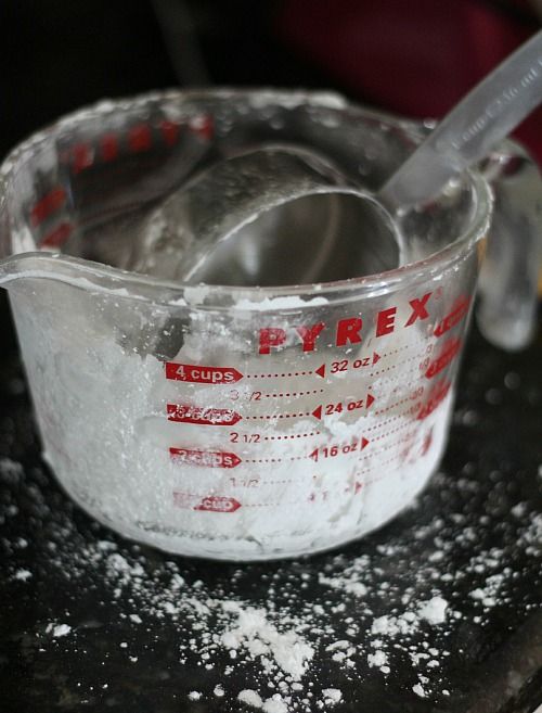 Powdered sugar in a glass liquid measuring cup