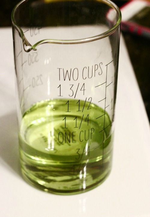 Liquid measuring cup with green grapeseed oil