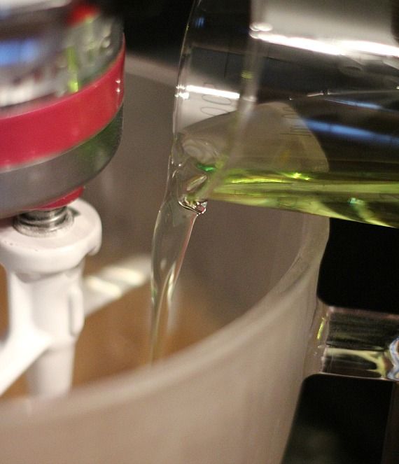 Grapeseed oil being added to a stand mixer bowl