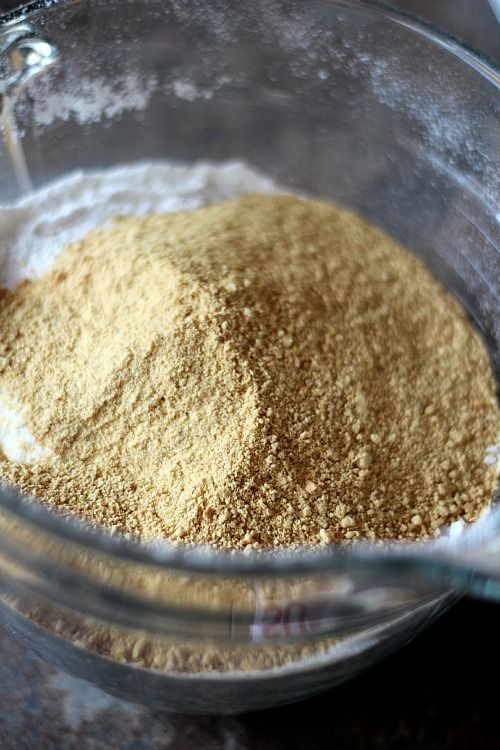 Graham cracker crumbs atop other dry ingredients in a mixing bowl