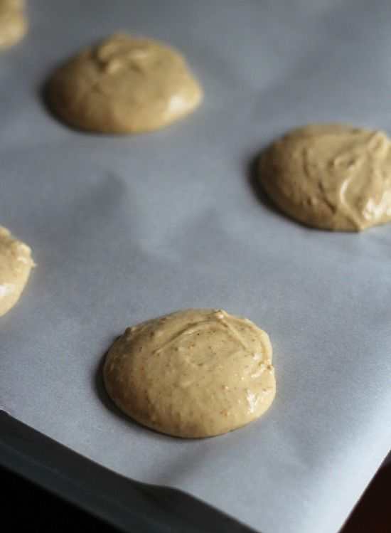 Circles of batter for key lime whoopie pies on a parchment-lined baking sheet