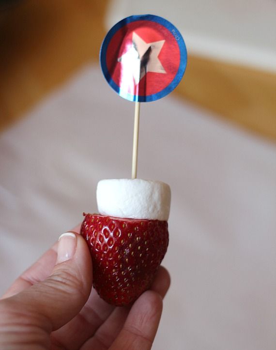 Fresh strawberry and a marshmallow half on a mini skewer with festive star decoration
