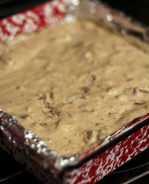 Oatmeal cream pie cheesecake batter spread in a foil-lined square pan