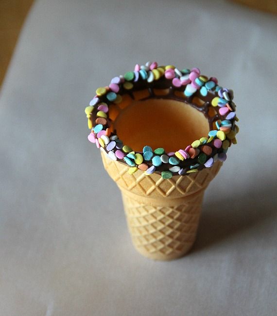 Ice cream cone rimmed with chocolate and sprinkles