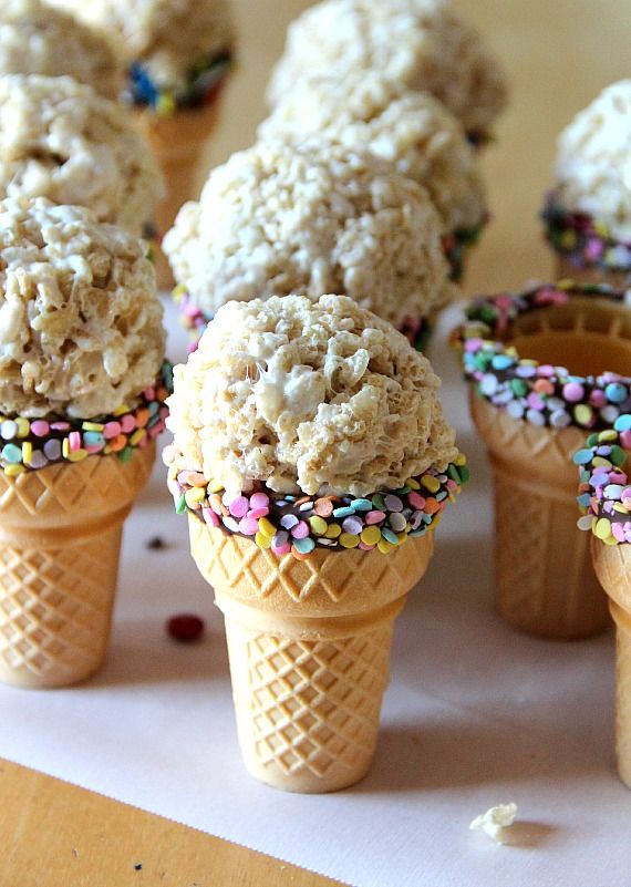 Chocolate and sprinkle rimmed ice cream cones with a round rice krispie treat in the place of ice cream