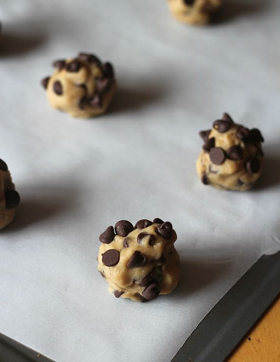 Malted chocolate chip cookie dough balls on a parchment-lined baking sheet