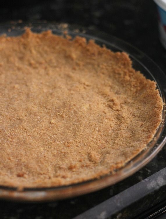 A graham cracker crust in a pie plate