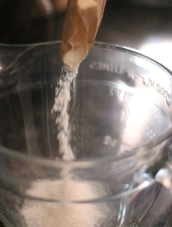 Powdered pudding mix being poured into a bowl
