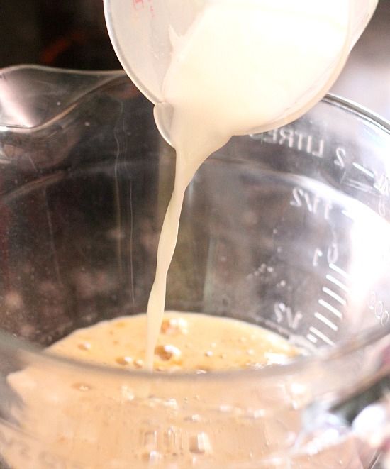 Milk being poured into a mixing bowl