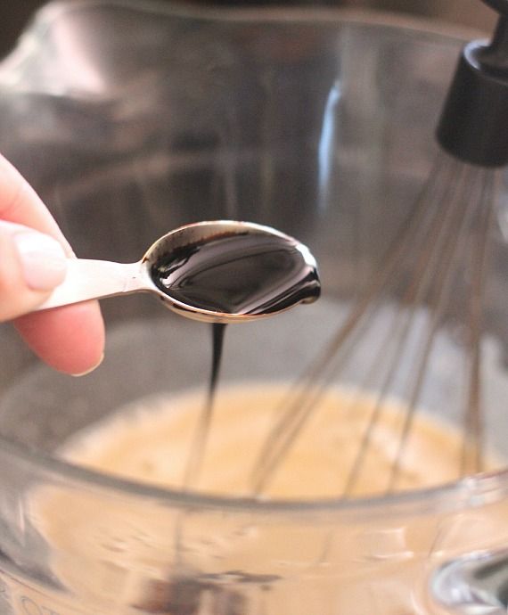 Root beer extract being added to a mixing bowl