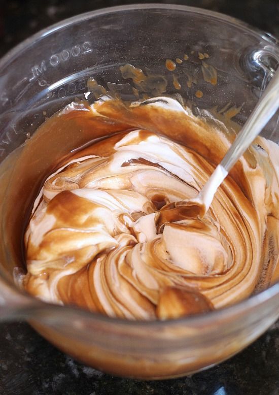Cool whip being stirred into root beer flavored batter