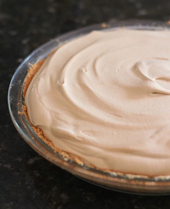 Creamy root beer pie in a graham cracker crust-lined pie plate