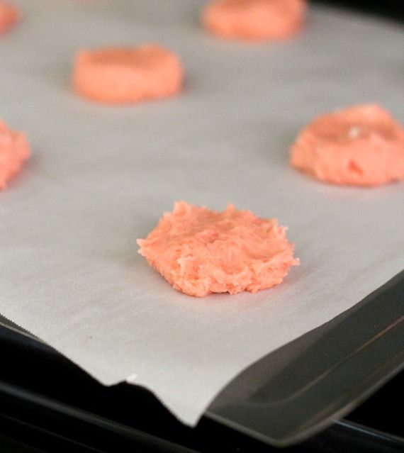 Pink dough on a parchment-lined baking sheet