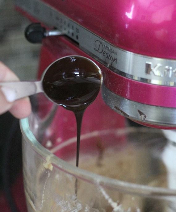 Chocolate syrup being added to a stand mixer bowl