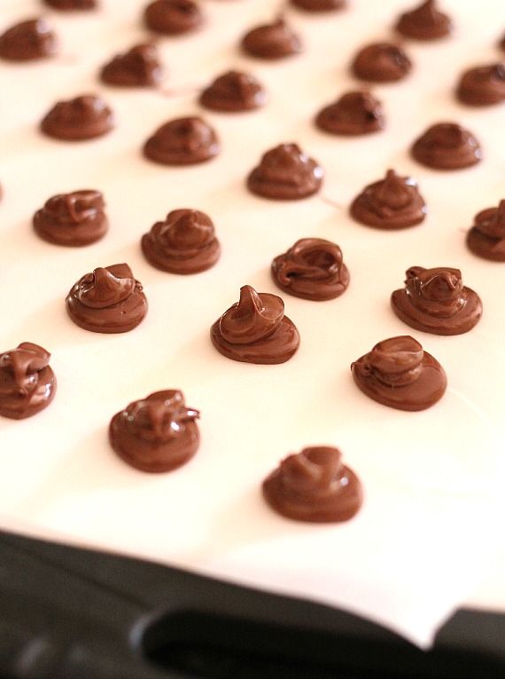 Swirls of chocolate batter on a parchment-lined baking sheet