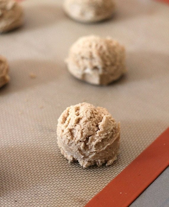 cookie dough balls on a baking sheet