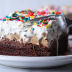 Brownie Bottom Ice Cream Cake is the best ice cream cake made with fudgy brownies, chocolate frosting, and cookie dough ice cream!