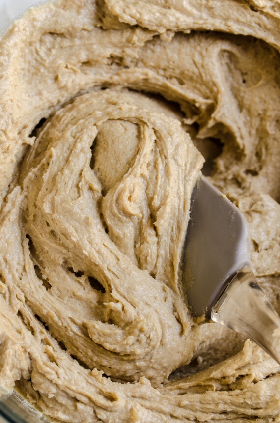 Close up of apple cake batter with a spatula.