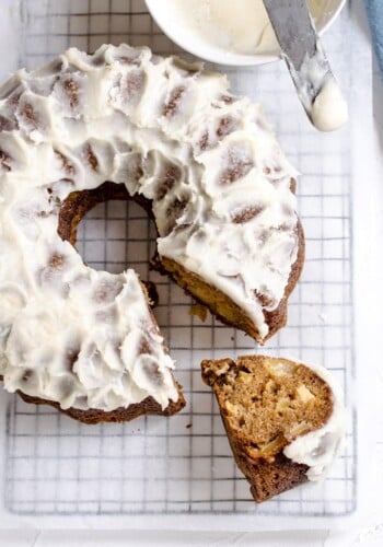 Brown butter cake with frosting on a cooling rack