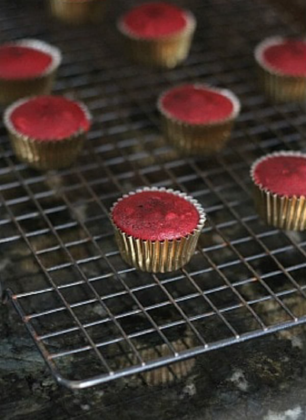 Mini red velvet cupcakes on a wire cooling rack