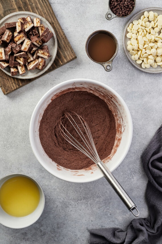 The ingredients for the brownie batter are whisked together in a mixing bowl.