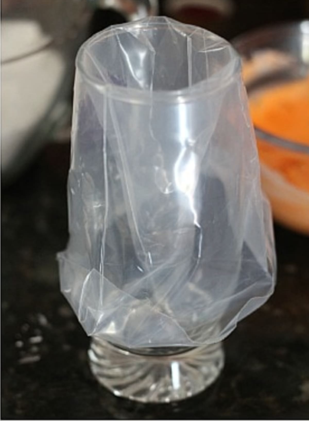 A piping bag in a glass cup folded over the edge ready to fill with frosting