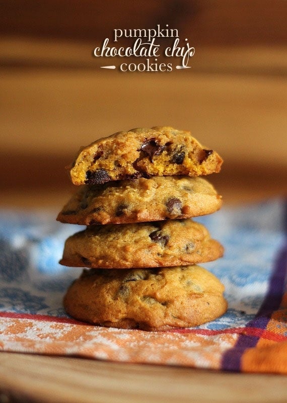 Four stacked pumpkin chocolate chip cookies.