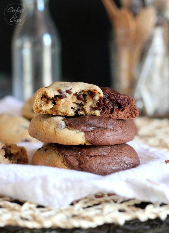 A stack of brookie cookies. The one on top has a bite taken out of it.