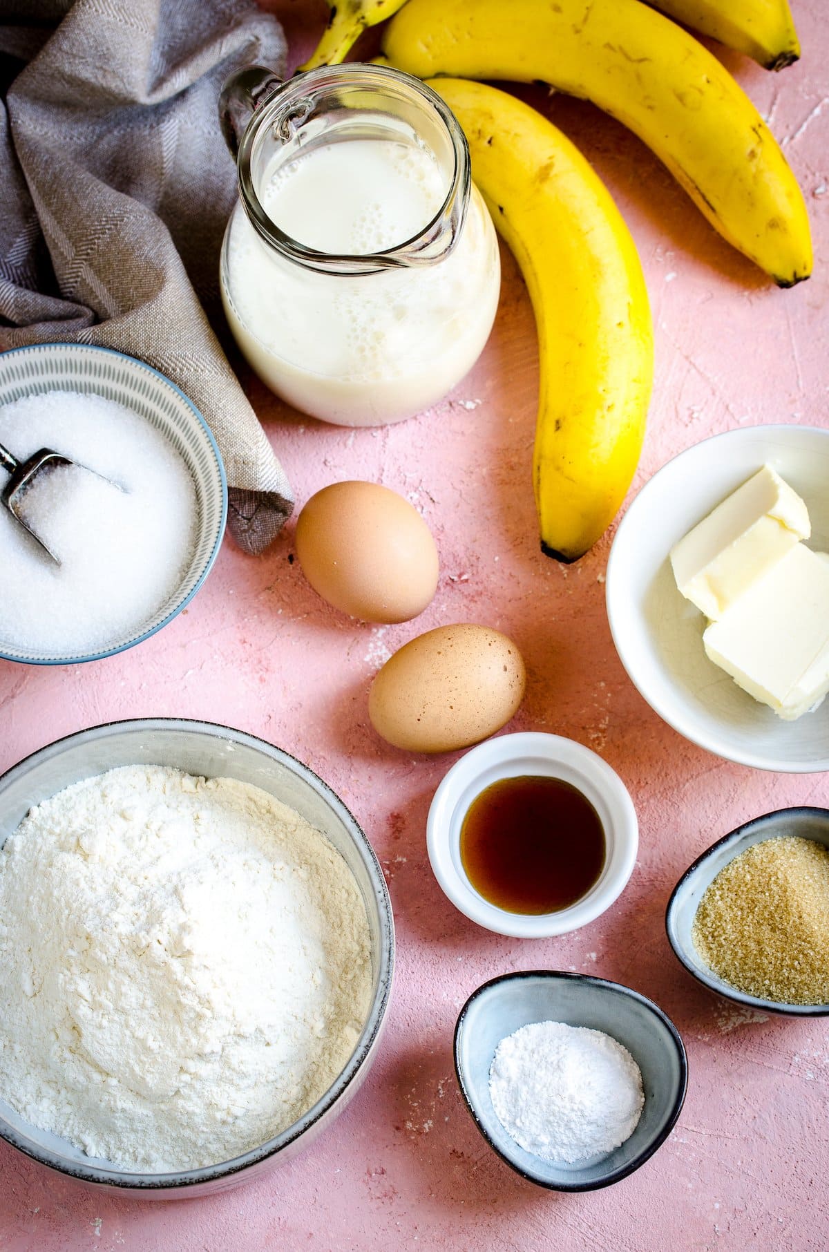 Banana crumb cake ingredients including bananas, butter, light brown sugar, baking powder, vanilla, eggs, flour, sugar, milk.