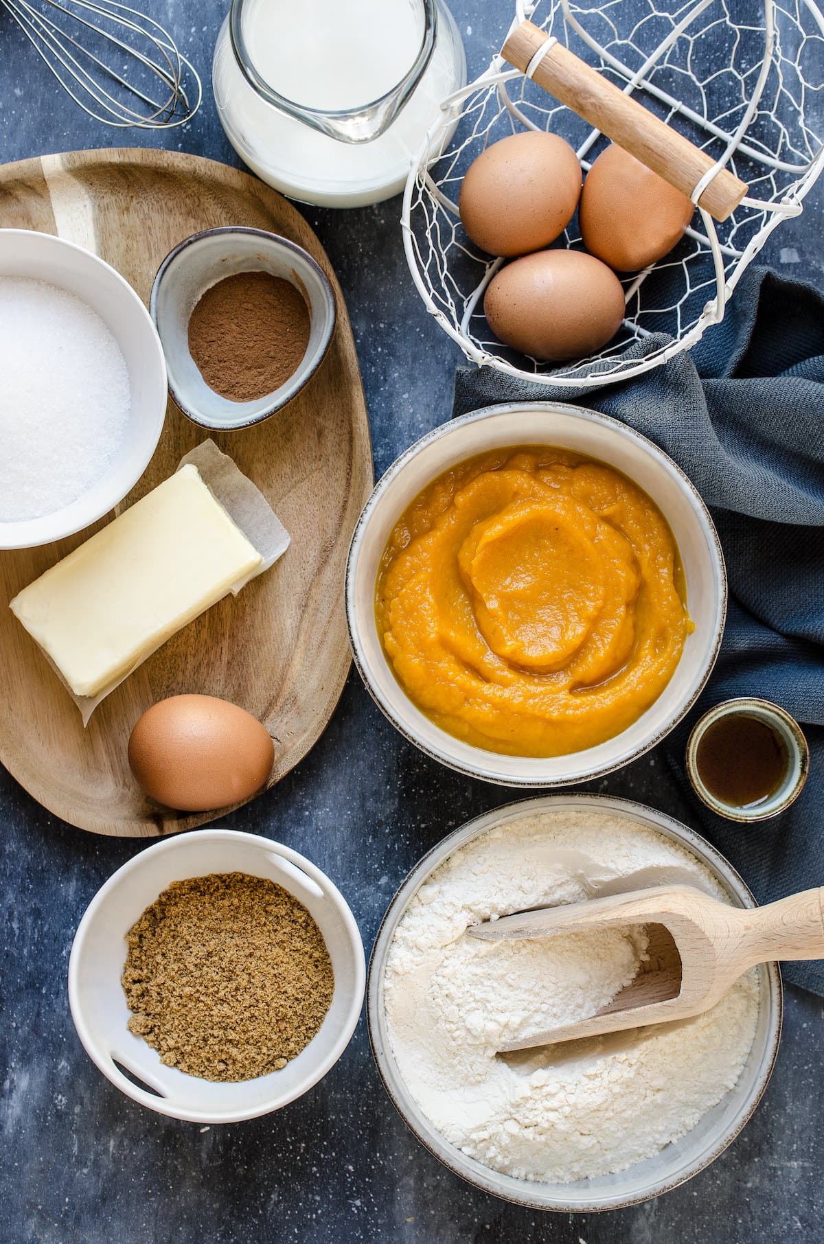 Ingredients for pumpkin cake in white bowls