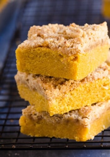 Stack of 3 slices of pumpkin coffee cake on a cooling rack