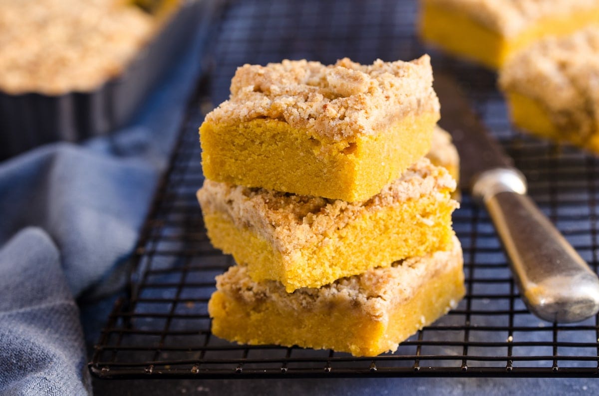 Stack of 3 slices of pumpkin coffee cake on a cooling rack