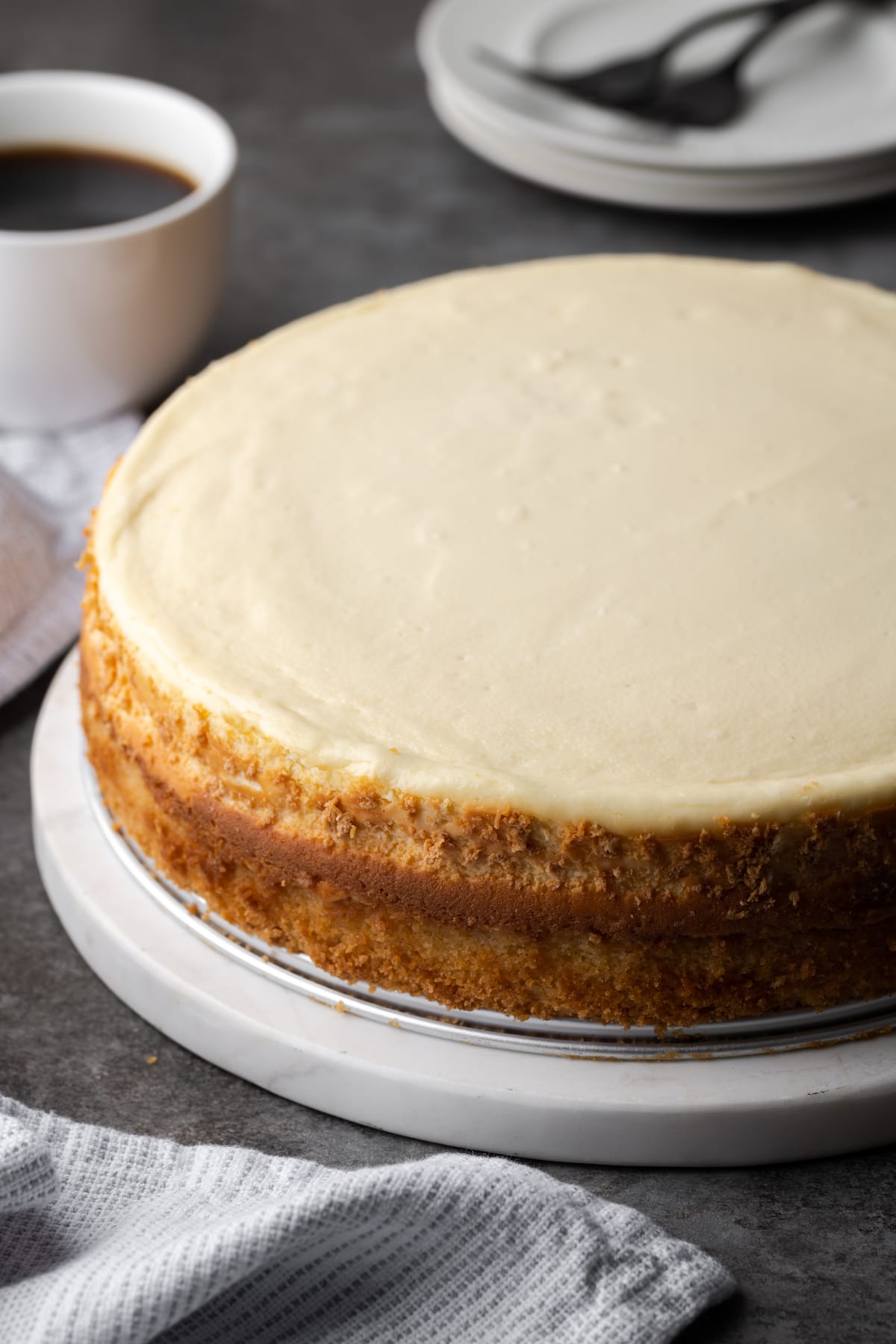 The baked Boston Cream Pie cheesecake released from the pan, on a plate.