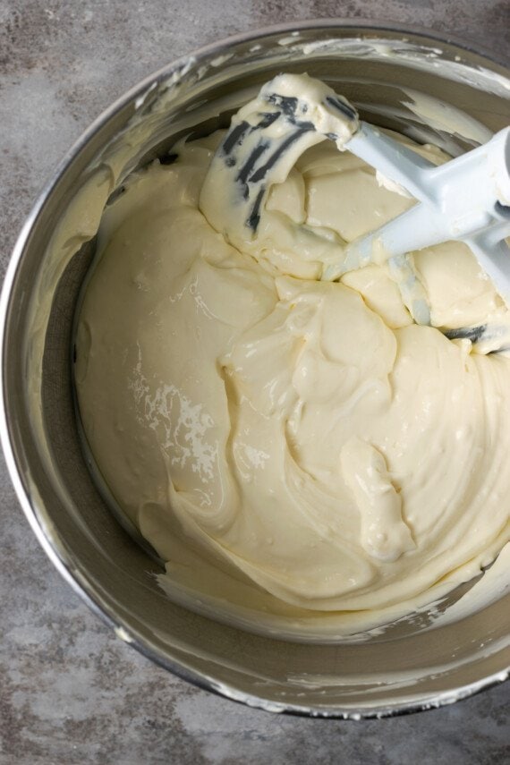 Cheesecake batter is combined in a stand mixer.