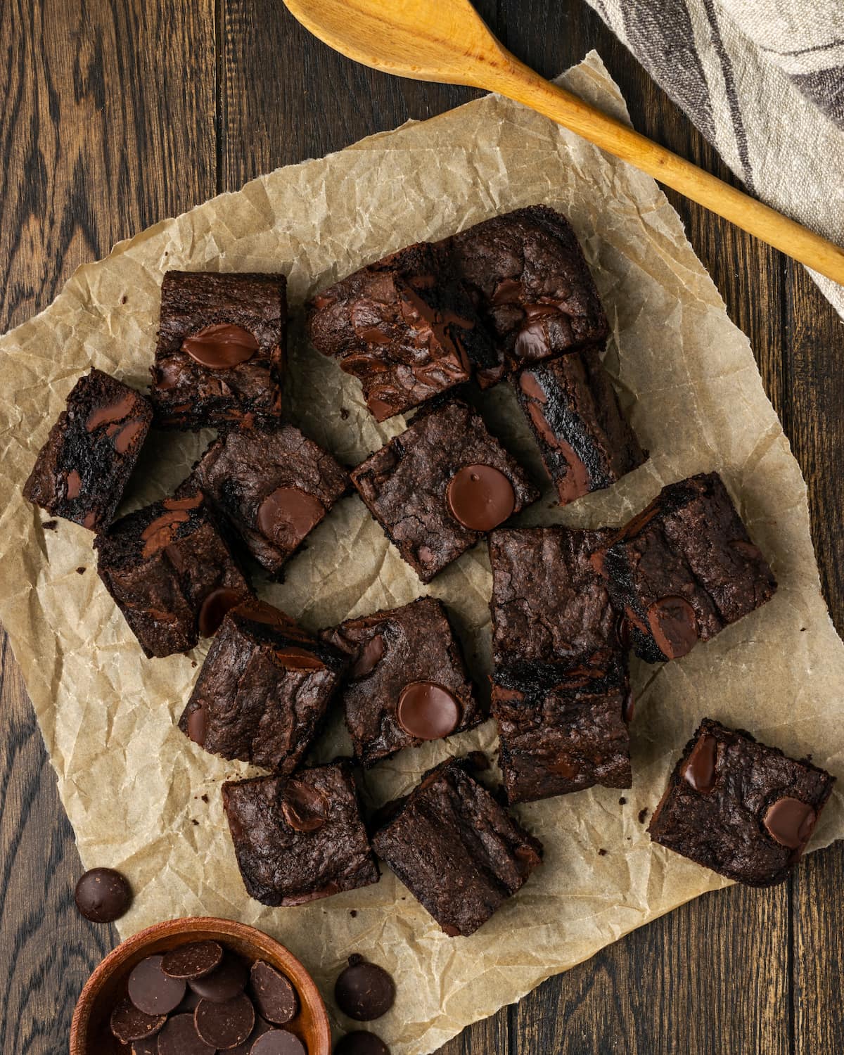 An overhead view of assorted cake mix brownies scattered on parchment.