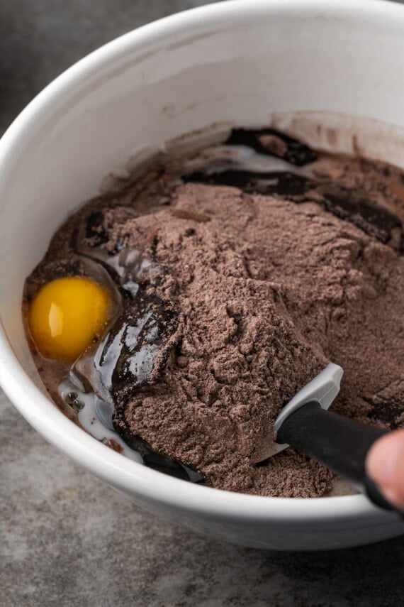 Stir cake mix brownie ingredients in a large bowl.