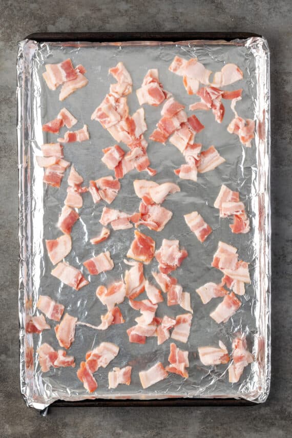 Scatter diced bacon on a baking sheet lined with foil.