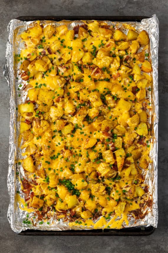 Cheesy Ranch Potatoes on a baking sheet after the cheese has melted.