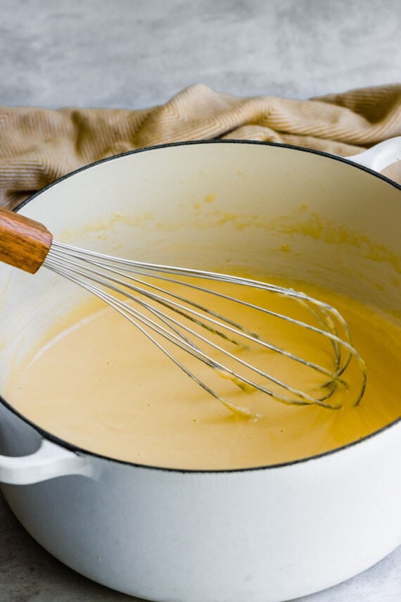Melted cheese whisked in a pot.
