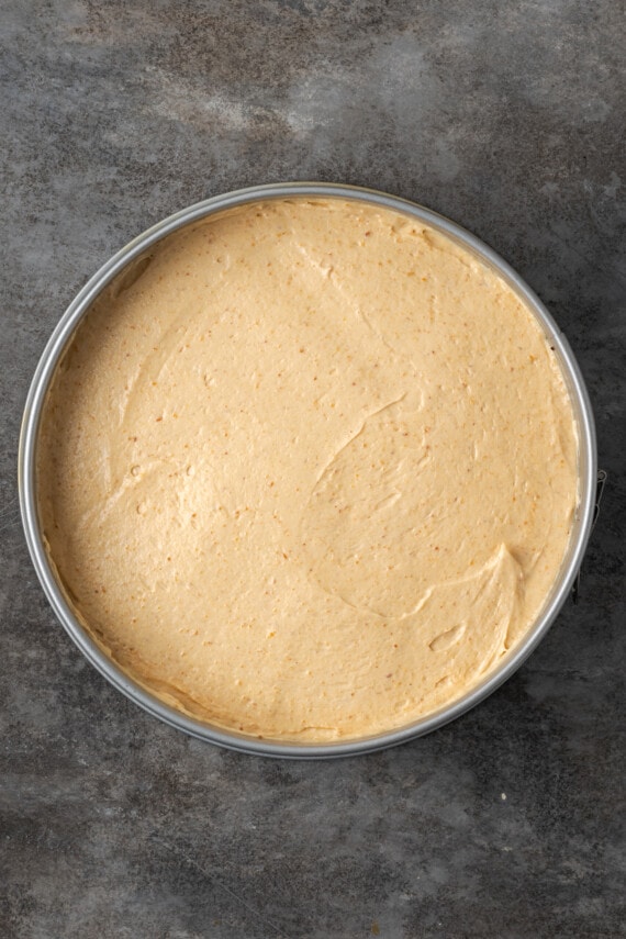 The first cheesecake layer in a springform pan.