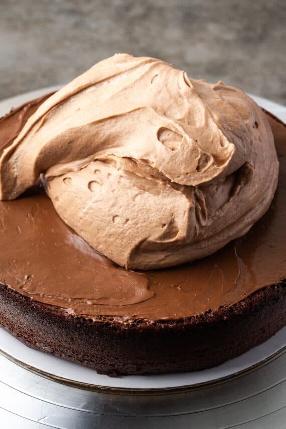 Chocolate hazelnut mousse piled over the first chocolate cake layer.
