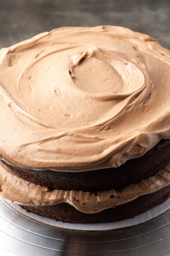 Assembled chocolate hazelnut cake topped with a thick layer of mousse.