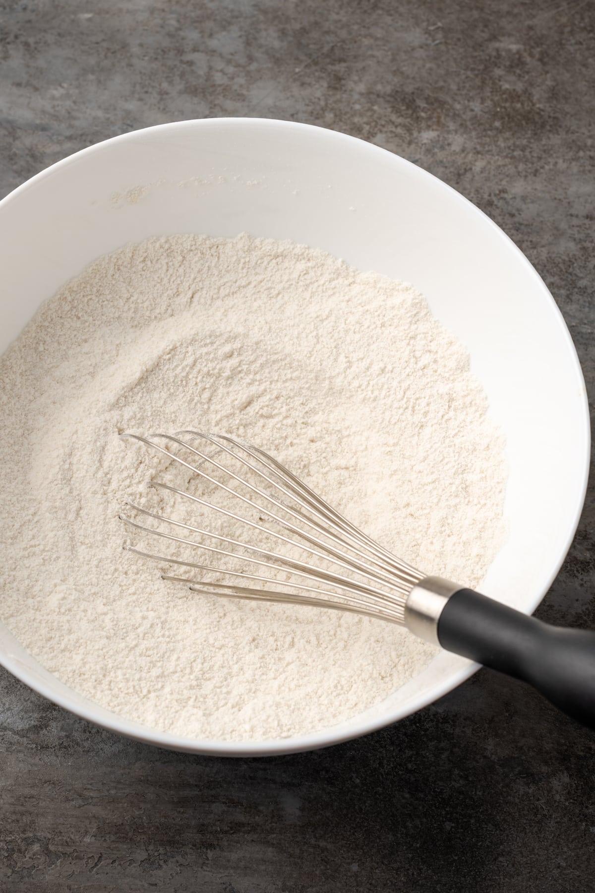 Dry ingredients whisked together in a mixing bowl.