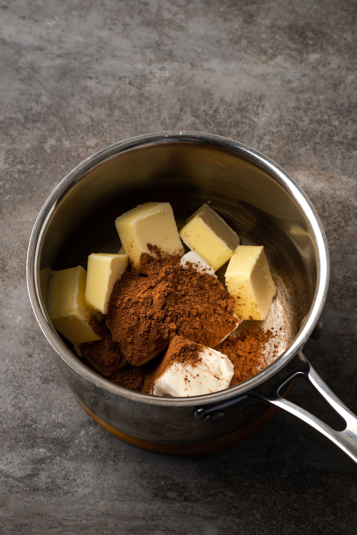 Cocoa powder, butter, and shortening combined in a saucepan.