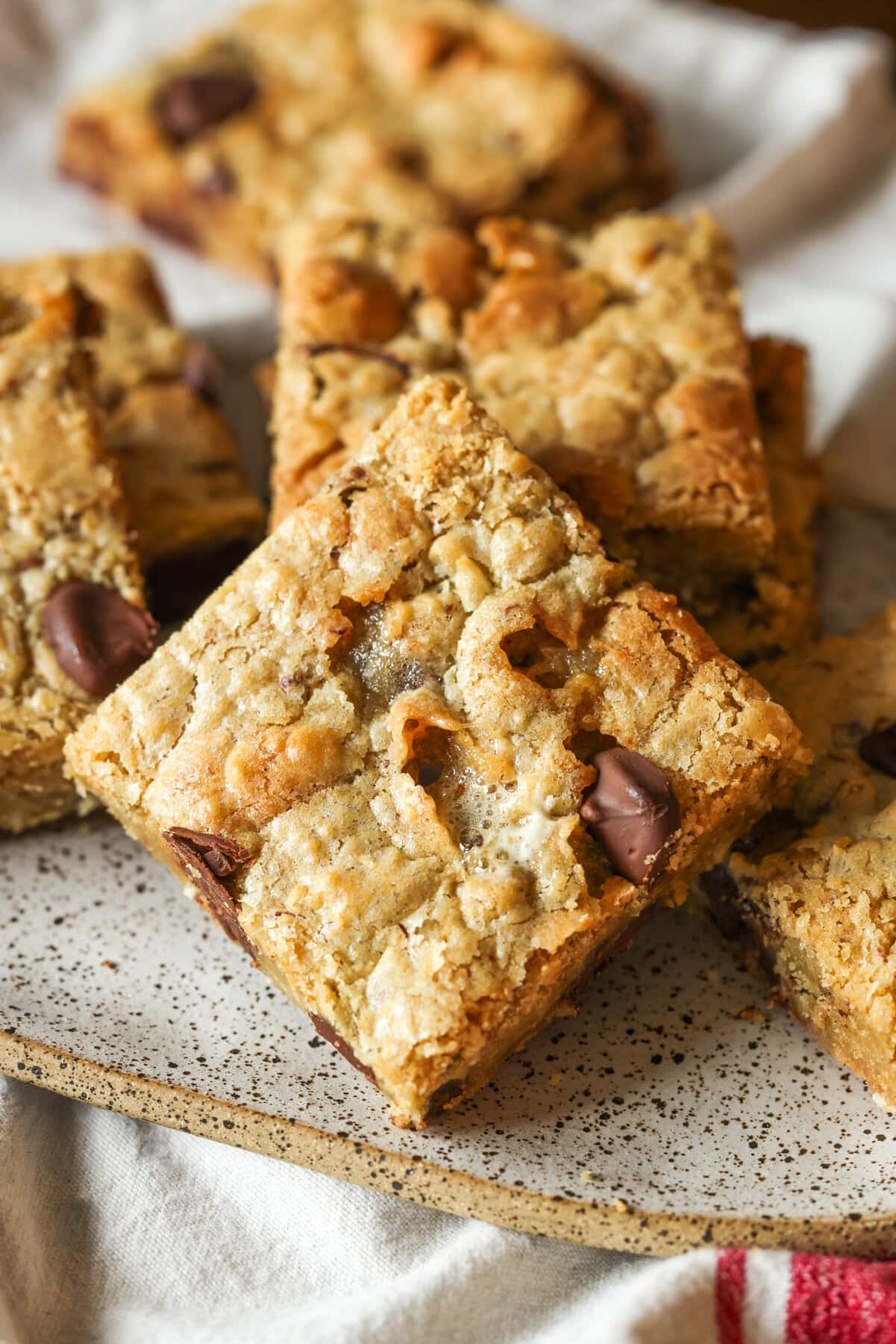 Blondie cookie bars cut into squares on a plate